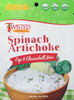 Creamy spinach artichoke dip mix served in a bowl with bread slices and fresh herbs